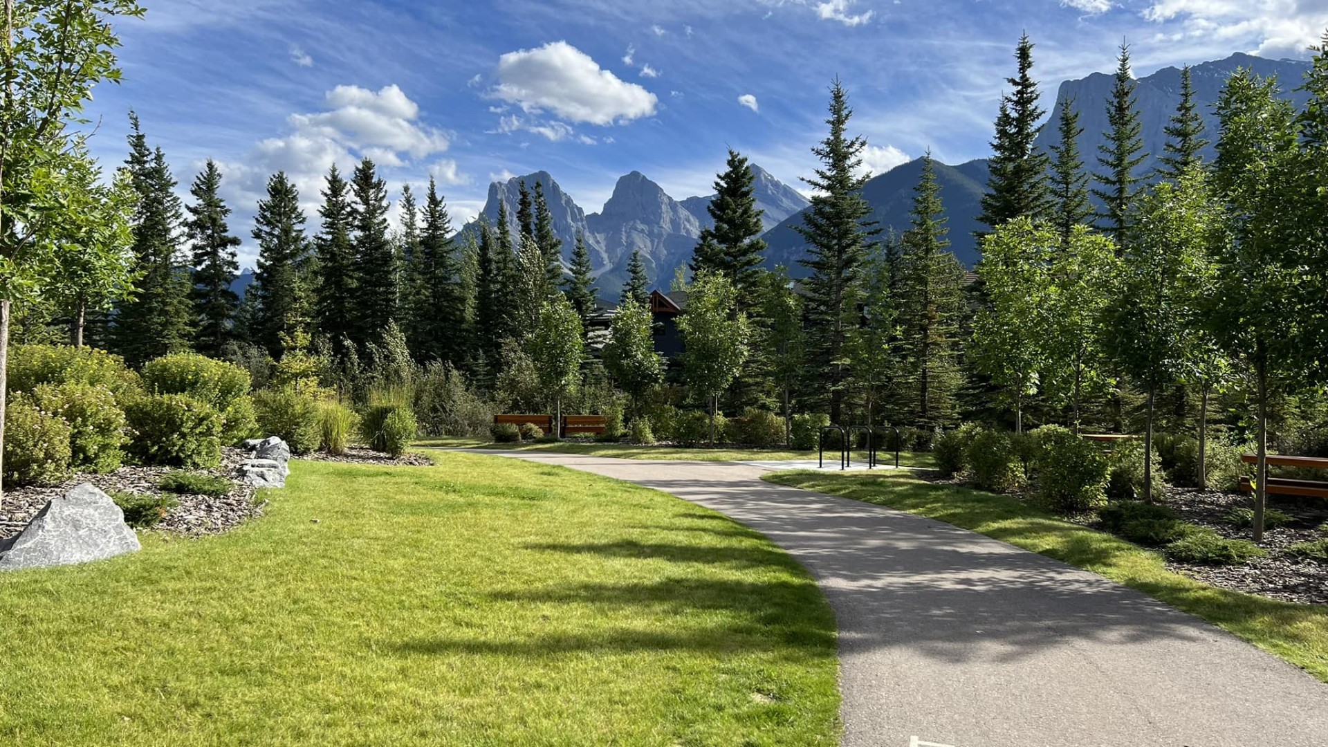 Three sisters mountains in the distance on a walking path